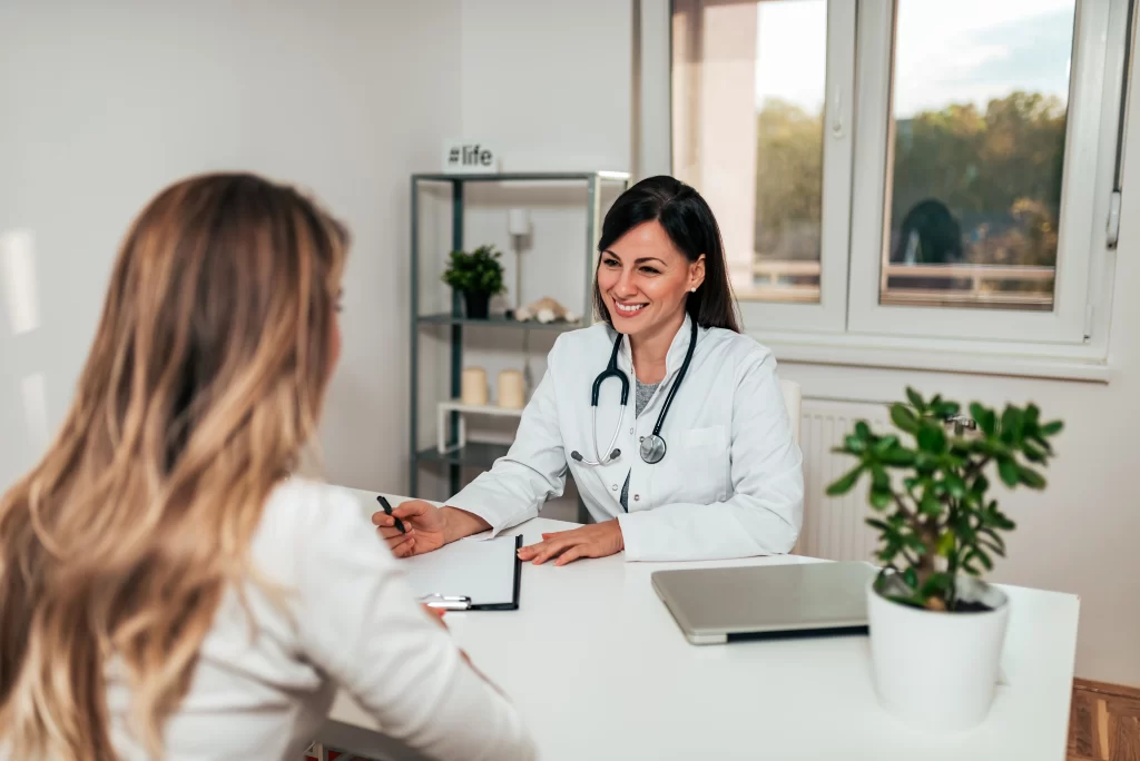 healthcare-medicine-concept-friendly-female-doctor-conversation-with-female-patient